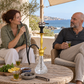 Aladin Alux Admiral Gold shisha pipe with adults, tea, flavour and charcoal in a coastal patio setting.