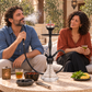 Aladin Alux Captain White shisha pipe with an adult couple, flavour and charcoal in a courtyard setting.