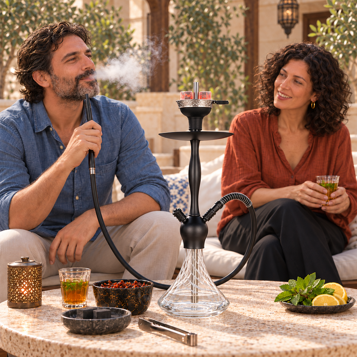 Aladin Alux Captain White shisha pipe with an adult couple, flavour and charcoal in a courtyard setting.